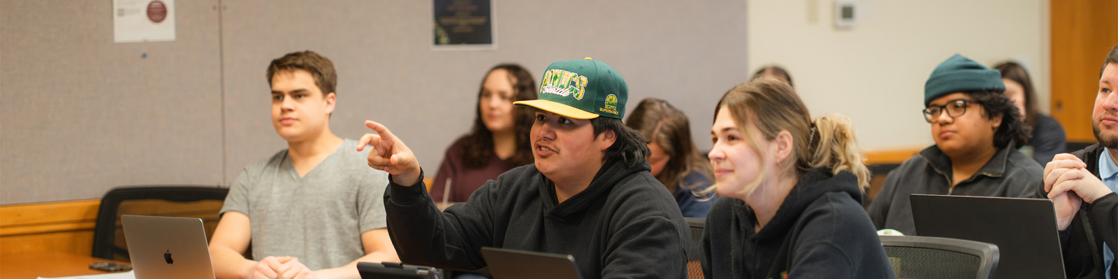 Three students engage in a classroom discussion in a Pastoral Ministries class.